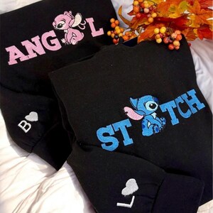 two black sweatshirts with the character Stitch's face embroidered on them, along with a floral arrangement of autumn leaves.