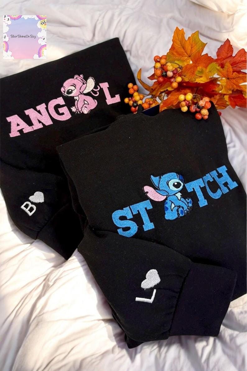 two black sweatshirts with the character Stitch's face embroidered on them, along with a floral arrangement of autumn leaves.