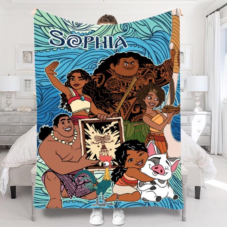 May include: A large, rectangular blanket featuring a cartoon illustration of characters from a popular animated movie. The blanket has a blue and teal background with the name "SOPHIA" in white script. The characters are in various poses.