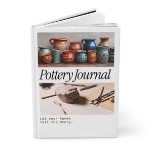 May include: A white hardcover book titled Pottery Journal with the subtitle Let your hands tell the story. The cover features two rectangular images: one showing various colorful ceramic pots and another displaying raw clay and metal sculpting tools.