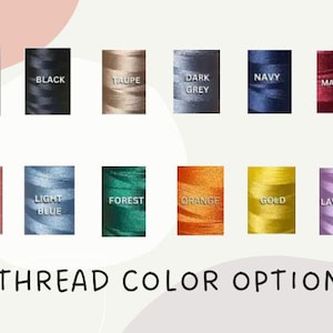 May include: Image showcasing a variety of thread color options. The image displays spools of thread in colors such as white, black, taupe, dark grey, navy, maroon, light pink, light blue, forest green, orange, gold, and lavender. Text at the bottom reads "THREAD COLOR OPTIONS."