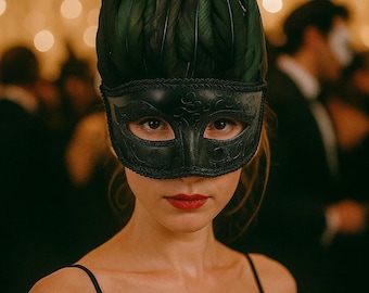 May include: A black masquerade mask with a feather headdress. The mask has an intricate design and is worn by a person with red lipstick. The background is blurred with warm-toned lights.