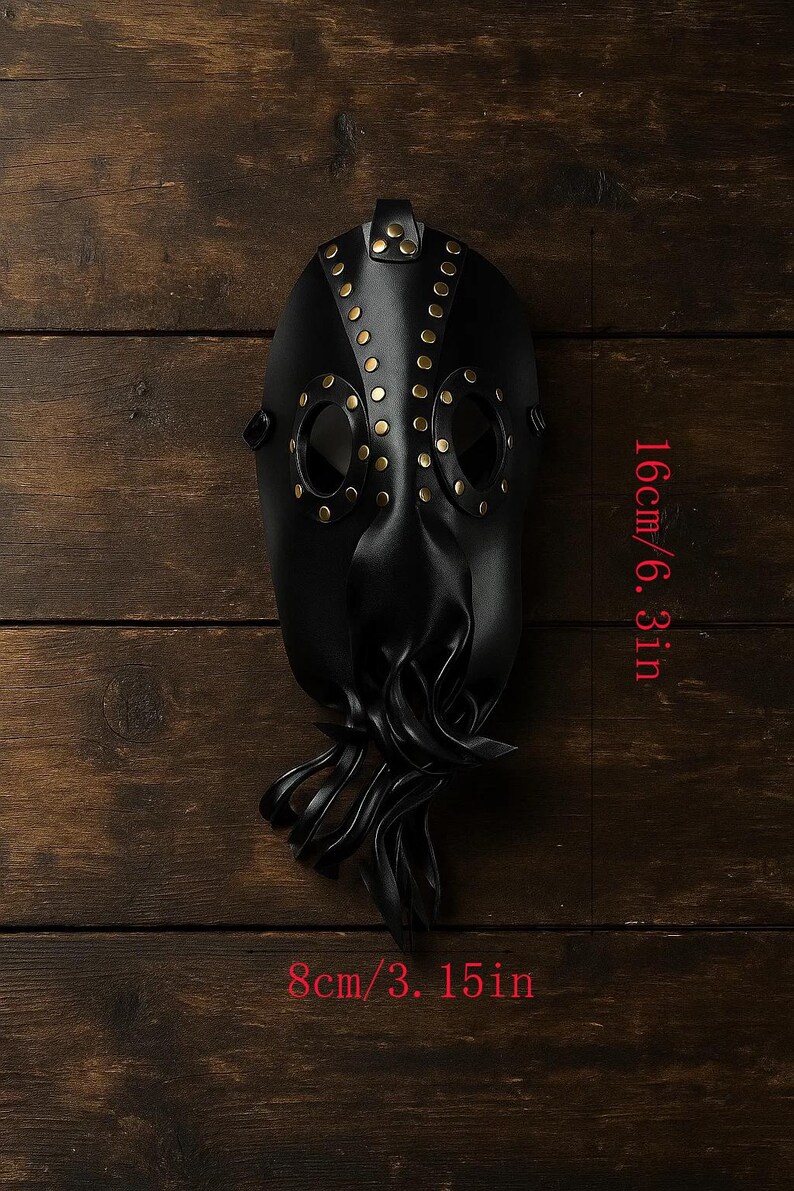 May include: A black plague doctor mask with brass rivets and eye holes. The mask is 6.3 inches (16 cm) tall and 3.15 inches (8 cm) wide. The mask has a beak-like nose and a strap for wearing.