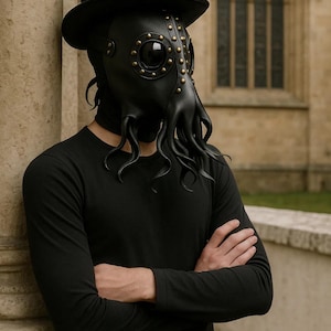 May include: Black leather plague doctor mask with brass rivets and tentacle-like extensions. The mask is paired with a black top hat and a black long-sleeve shirt. The mask has large, round eye openings.