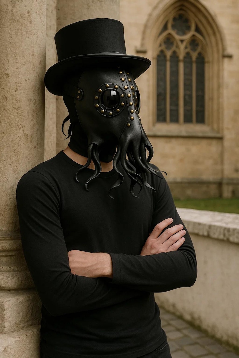 May include: Black leather plague doctor mask with brass rivets and tentacle-like extensions. The mask is paired with a black top hat and a black long-sleeve shirt. The mask has large, round eye openings.