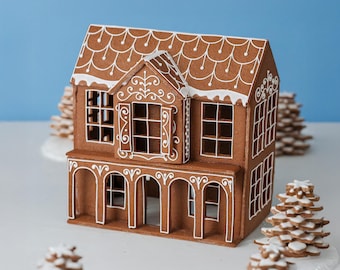May include: A brown gingerbread house with white icing details, featuring a shingled roof, arched porch columns, and window frames. The structure is decorated with intricate white piping patterns on the roof, walls, and around the windows.