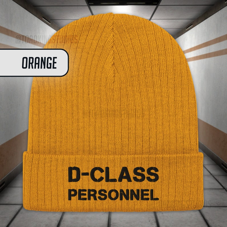 May include: Orange knitted beanie with the text "D-CLASS PERSONNEL" in black.