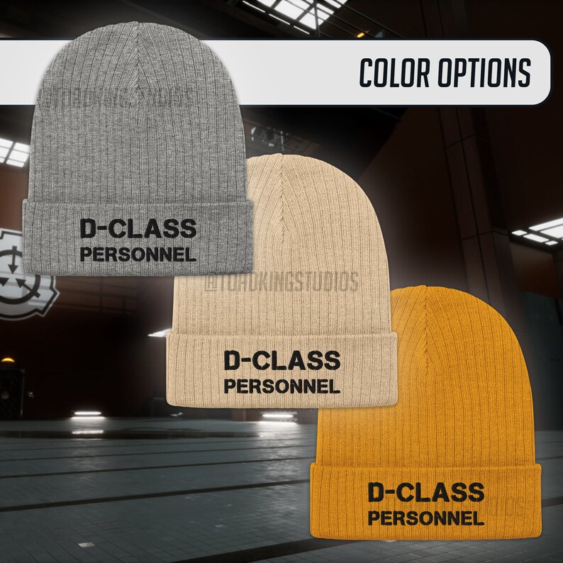 May include: Three knitted beanies in grey, beige, and yellow with the text "D-CLASS PERSONNEL" in black.