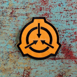 May include: Embroidered patch featuring the SCP Foundation logo. The patch has a yellow background with a black circular design and three arrows pointing inward. The patch is outlined in black.