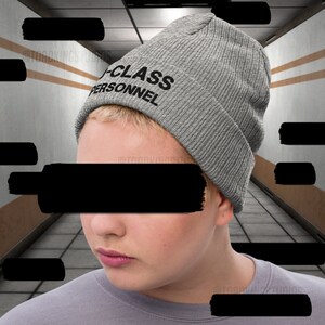 May include: A grey beanie with the text "A-CLASS PERSONNEL" embroidered in black.