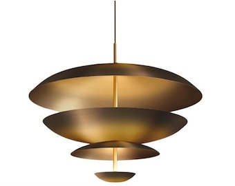 May include: A modern, tiered pendant light fixture with a metallic gold finish. The light has four stacked, saucer-shaped shades, suspended from a central rod. The fixture is designed for overhead lighting.