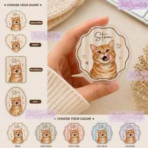 May include: A clear acrylic coaster featuring a custom illustration of an orange tabby cat with the name Stom printed above it. The design includes small heart accents on a beige striped background. The coaster has a scalloped edge shape.