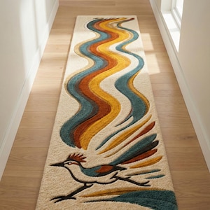 May include: A rectangular beige rug with a roadrunner bird design and wavy lines in blue, orange, and yellow. The rug is in a hallway with wooden flooring and white walls. The rug's design is reminiscent of the 1970s.