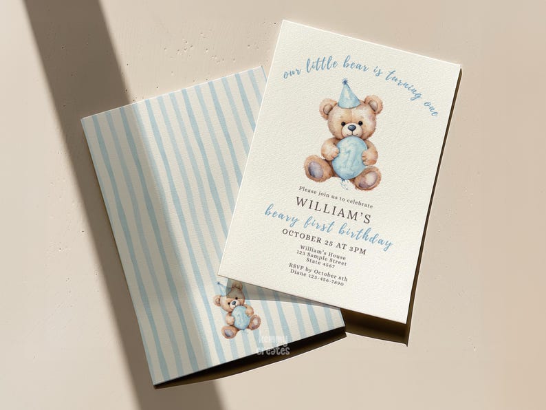 May include: A light beige birthday invitation with a watercolor illustration of a teddy bear holding a number one balloon. The text reads "our little bear is turning one" and "William's beary first birthday". The envelope has blue and white stripes.