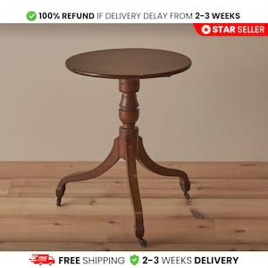May include: A dark brown, antique-style side table with a round top and a pedestal base. The table has three curved legs with small wheels. The text "100% REFUND IF DELIVERY DELAY FROM 2-3 WEEKS" and "FREE SHIPPING 2-3 WEEKS DELIVERY" are visible.