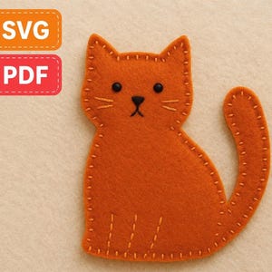 May include: An orange felt cat with black eyes and a stitched outline. The cat has a curved tail and stitched whiskers. The image includes orange and red rectangular labels with the text "SVG" and "PDF".