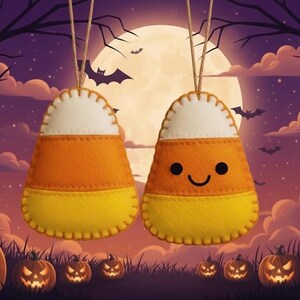 May include: Two felt candy corn ornaments with a white top, orange middle, and yellow bottom, hanging from twine. One has a smiling face. The background features a full moon, bats, and jack-o'-lanterns, creating a Halloween theme.