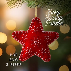 May include: A red felt star ornament featuring white hand-stitched snowflake embroidery and a white blanket stitch along the edges. The star hangs from a gold cord. Text on the image reads: Easy Sewing Pattern, PDF, SVG, 3 SIZES.