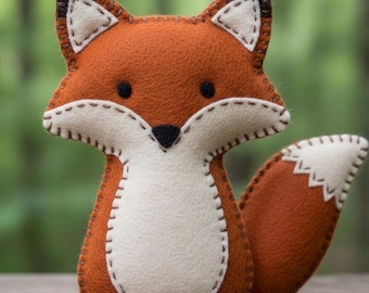 May include: A handmade felt fox toy in shades of orange, white, and brown. The fox has a stitched outline, black eyes, and a white chest. The tail has a white tip. This plush toy is a charming addition to any nursery or child's room.