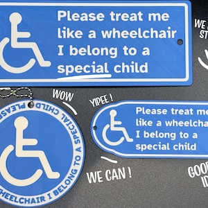 May include: Blue signs and a keychain featuring the wheelchair symbol and the text "Please treat me like a wheelchair, I belong to a special child." The signs are in various shapes. The keychain is circular.