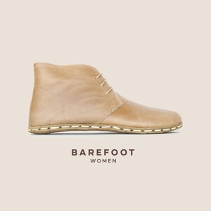 Hand-crafted beige full-grain leather ankle boot with grounding design — barefoot comfort meets natural elegance.
