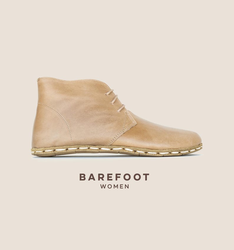 Hand-crafted beige full-grain leather ankle boot with grounding design — barefoot comfort meets natural elegance.