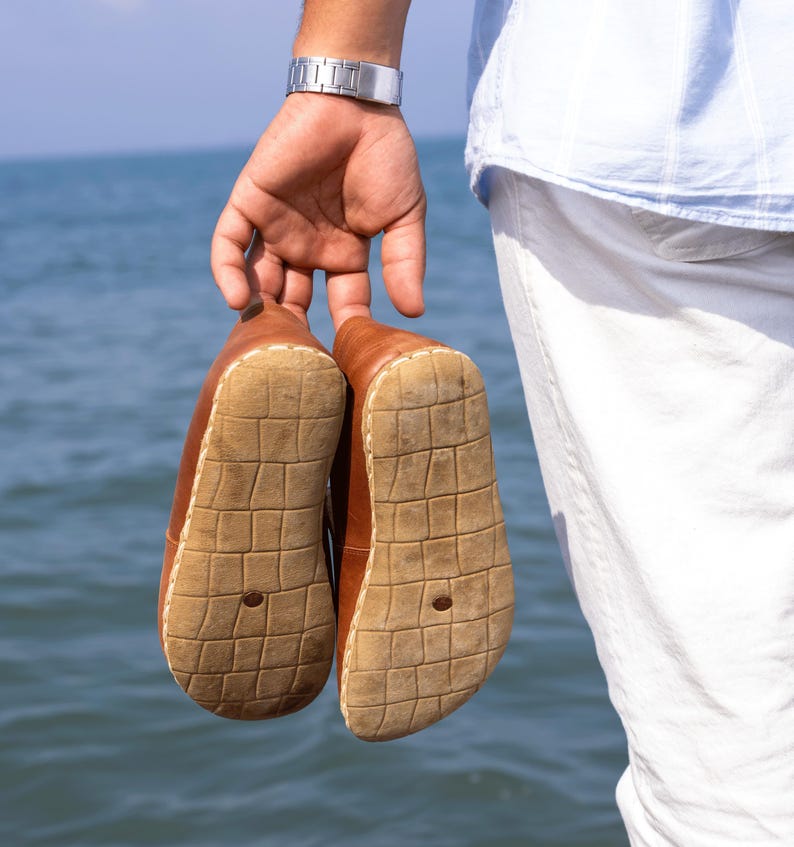 Slip-on convenience combined with barefoot engineering and grounding intent.