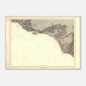 May include: Antique nautical chart print titled "Partie de la Cote Sud" in a wooden frame. The map features detailed coastlines, depth soundings, and navigational information. The chart is in shades of beige and brown, with the text in French.