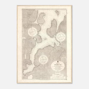 May include: A framed nautical chart of Sullom Voe featuring detailed topographical lines, depth soundings, and three compass roses. The map is printed in shades of beige and grey, displaying geographical features, land contours, and maritime data.