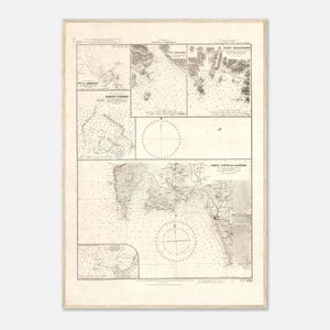 May include: A vintage nautical chart print, framed in a light wood. The chart features detailed illustrations of coastal areas, including depth soundings, navigational markers, and place names. The print has a sepia tone, giving it an antique appearance.