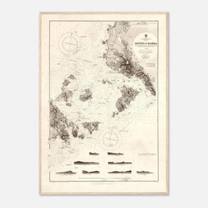 May include: A framed nautical chart of the Sound of Barra, featuring detailed coastlines, depth soundings, and navigational markers. The map is in sepia tones, with the title "Sound of Barra" in the upper right corner. The frame is a light wood color.