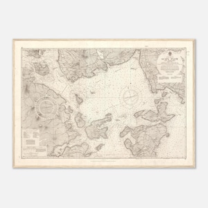 May include: A vintage nautical chart titled Scapa Flow and Approaches, printed in black ink on off-white paper. The map displays detailed coastal outlines, depth soundings, compass roses, and topographical markings of the islands and surrounding waters.