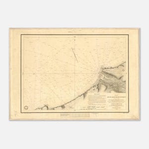 May include: Antique nautical chart with detailed lines and text. The map features a coastal area with landmasses, depth soundings, and navigational markers. The chart is framed with a beige border and has text in the lower right corner.