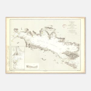 May include: A framed vintage map of the Corinth region, featuring detailed illustrations of the coastline, mountains, and sea, with text in French. The map is in shades of beige, grey, and brown, with a classic, historical aesthetic, framed in light wood.