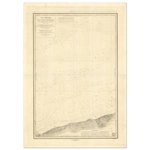 May include: A vintage nautical chart of the French coastline, with detailed cartography in black ink on aged paper. The map includes text in French, showing the coastline and sea depths. The chart is framed with a decorative border.
