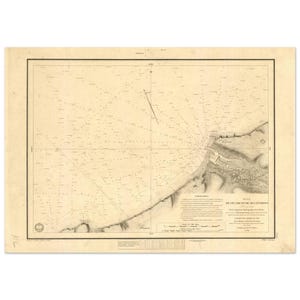 May include: Antique nautical chart with detailed lines and text, featuring a coastal area. The map is printed on aged paper, with a rectangular border and a detailed illustration of the coastline. The text includes the title "Plan de l'E'camp et de ses environs".