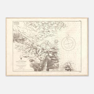 May include: An antique nautical chart of Loch Skiport, framed in a light wood. The map features detailed topographical and hydrographical information, with a compass rose and depth soundings. The chart is in shades of gray and beige.