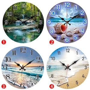 May include: Four round wall clocks with different nature scenes. One clock features a waterfall in a forest, another has a seashell on a beach, and two others depict beach sunsets. Each clock has black hands and Arabic numerals.