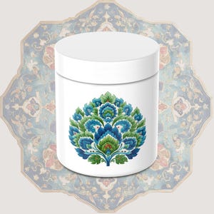 May include: White cylindrical container with a floral design in shades of blue, green, and red. The design is centered on the container. The background features a patterned, ornate design in blue, red, and beige.