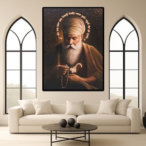 May include: A framed portrait of a spiritual figure with a white beard and turban, holding a beaded necklace. The image is set against a dark background with a golden halo and text. The artwork is displayed above a white sofa in a modern living room.