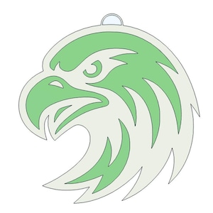 May include: A green and white eagle head pendant with a small loop at the top for hanging. The eagle's head is stylized with a green interior and white outline, creating a bold, graphic design. The pendant is likely made of metal or a similar material.