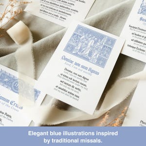 May include: Cards with elegant blue illustrations and text, inspired by traditional missals. The cards feature detailed blue artwork and calligraphy, with a soft, neutral background and white ribbon.
