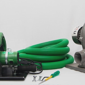 May include: An assortment of industrial equipment, including a green and silver power tool with a handle, a coiled green hose, and a gray blower fan. A screwdriver and small hardware are also present.