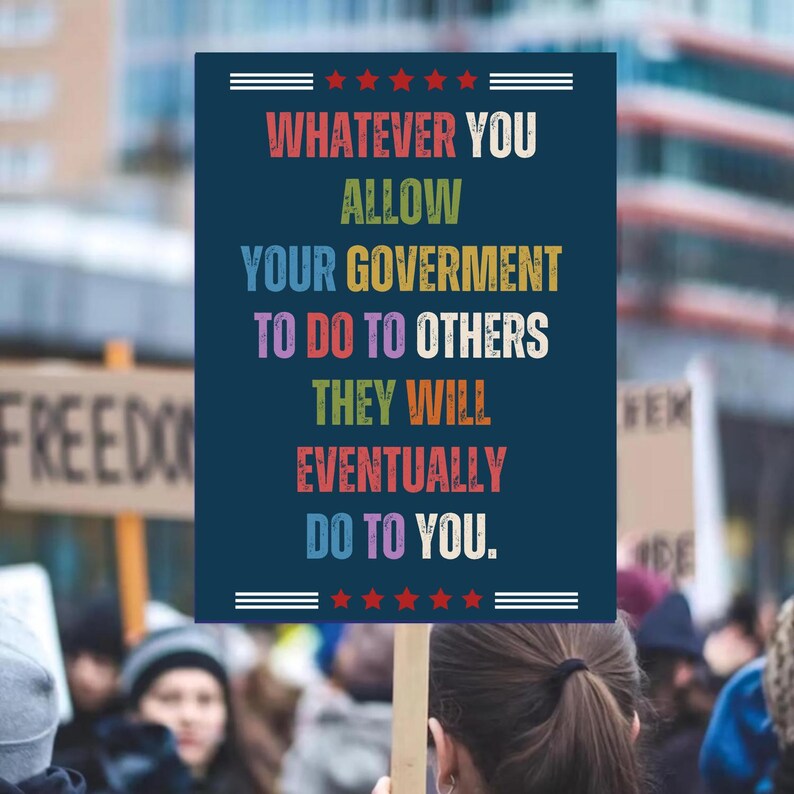 K&ouml;nnte beinhalten: Ein marineblaues Schild mit dem Text "WHATEVER YOU ALLOW YOUR GOVERNMENT TO DO TO OTHERS THEY WILL EVENTUALLY DO TO YOU." Das Schild hat rote Sterne und wei&szlig;e Linien oben und unten. Das Schild wird in einer Menschenmenge hochgehalten.