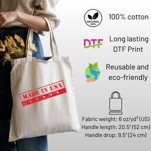 May include: Cream-colored tote bag with the text "MADE IN USA" in a red stamp. The bag is made of 100% cotton and features a DTF print. Handle length is 20.5 inches (52 cm), and the handle drop is 9.5 inches (24 cm).