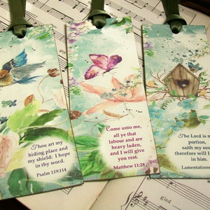 May include: Three watercolor bookmarks with floral designs and inspirational bible verses. The bookmarks feature a bluebird, a butterfly, and a birdhouse.