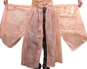 May include: A pink sheer skirt with a sequined waistband. The skirt is open in the front and has a flowing, layered design.