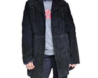May include: A long black suede jacket with a notched collar and a single button closure. The jacket has a cinched waist and a slightly flared hem.