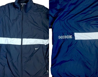 May include: A black and white Nike windbreaker jacket with a reflective stripe and the word "NIKE" on the back.