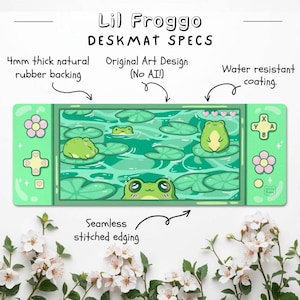 May include: A green deskmat featuring a frog-themed design with lily pads and frogs. The deskmat has a water-resistant coating, seamless stitched edging, and a 4mm thick natural rubber backing. The text "Lil Froggo DESKMAT SPECS" is at the top.